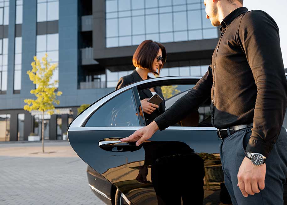 Man holding car door for smart business woman - Crawley Cars Logo